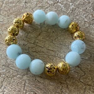 12mm matte blue jade and gold plated lava gemstone bracelet.